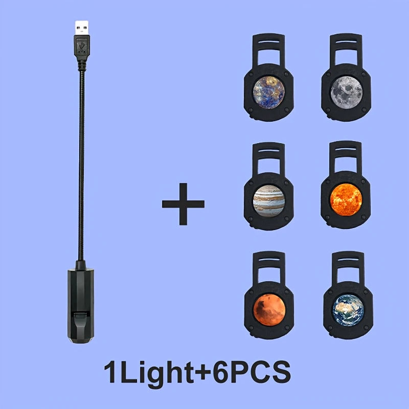 Proyector USB negro acompañado de seis láminas de temática espacial.