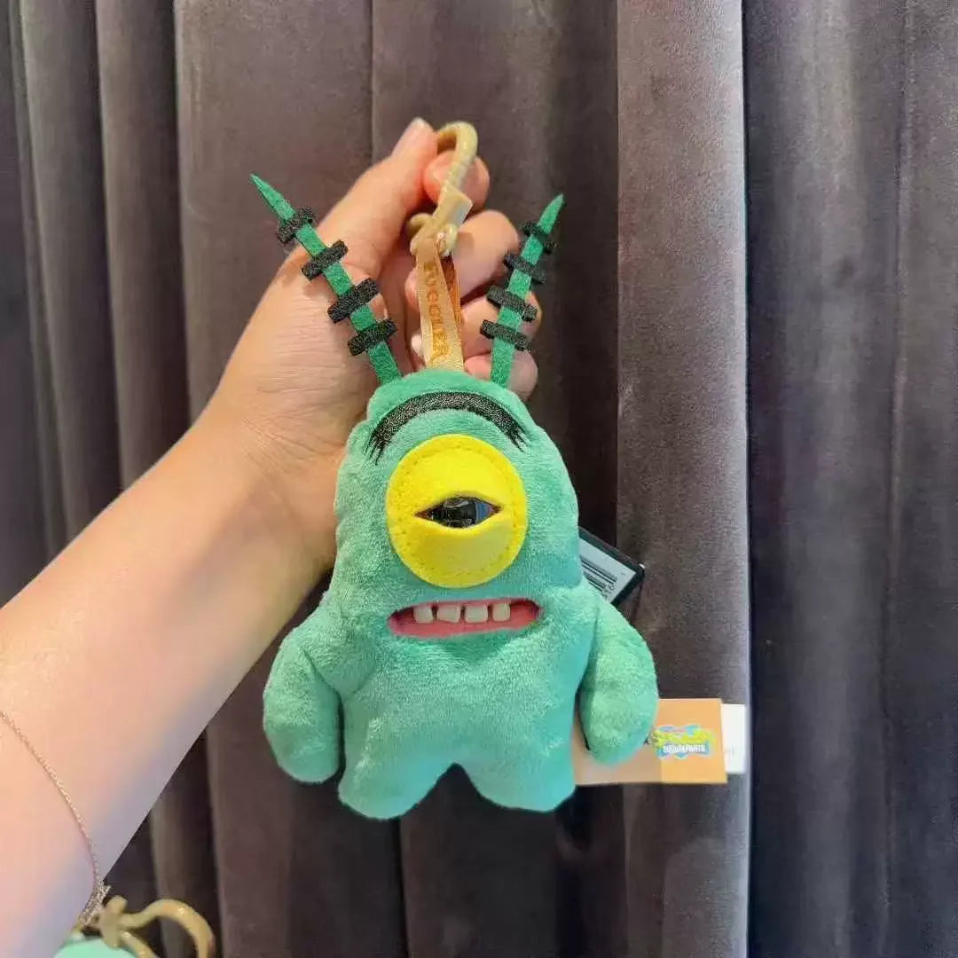 Llavero de peluche verde con un ojo grande y dos antenas